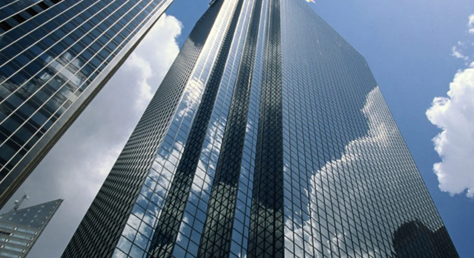 고층 빌딩의 유리창과 구름이 낀 하늘 